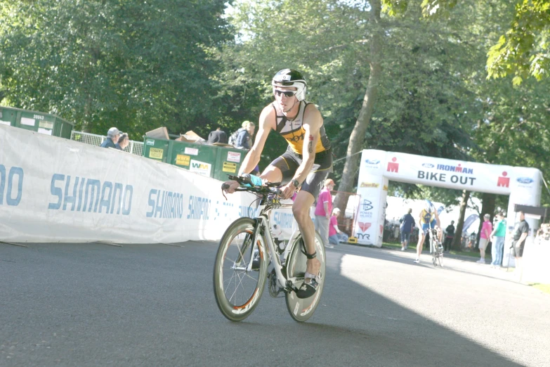 woman in bib riding her bicycle down a race course