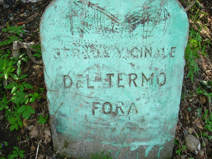 this old grave headstone has graffiti on it