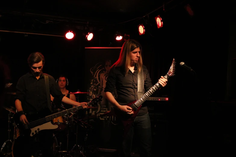 band playing music in dark room on stage