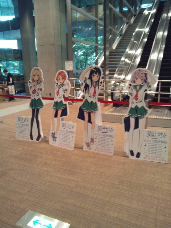 some paper dolls standing in the middle of a lobby