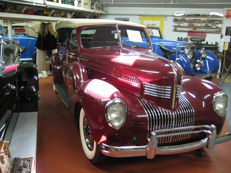 vintage cars on display in a car shop