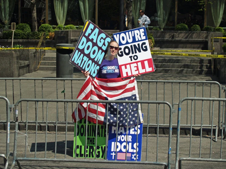 political signs set up behind barricades with words on them