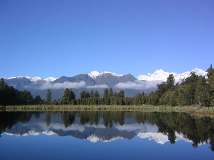 a beautiful lake sits in front of the mountains