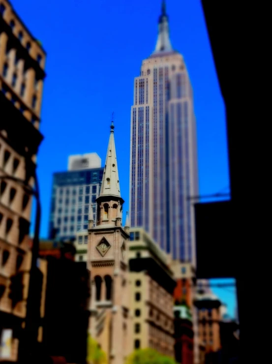 a tall building in front of the city skyline