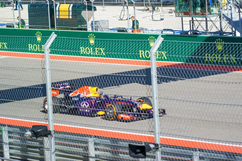 a man driving his car around the track