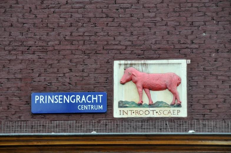 there is a sign and a red horse on the side of a building