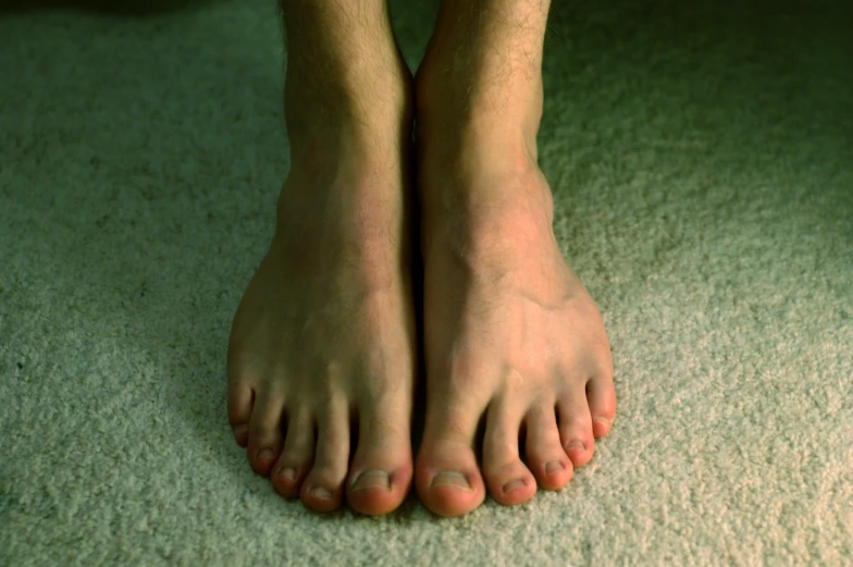 an overhead view of a persons bare feet and feet