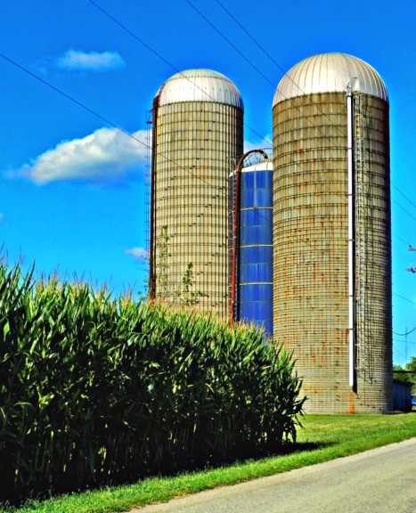 two very big silos standing near a road