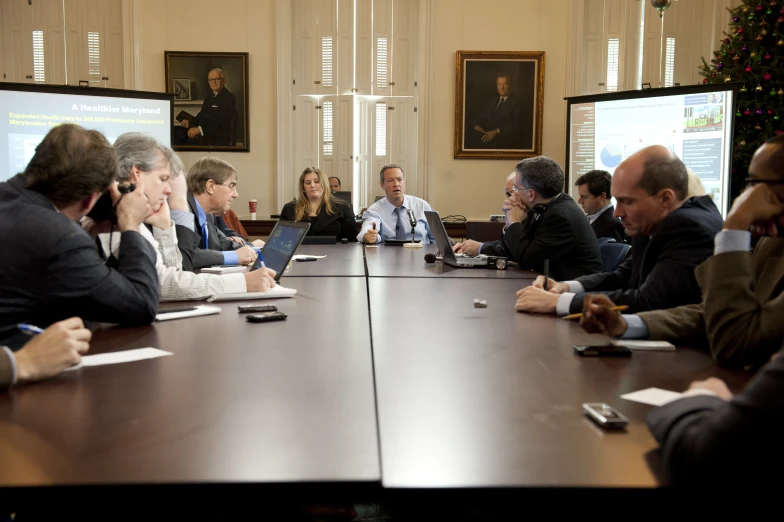 many people sitting around a conference table and having a meeting