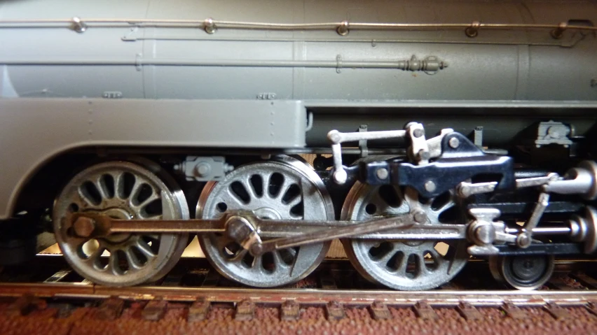 a close up of a train engine with several wheels
