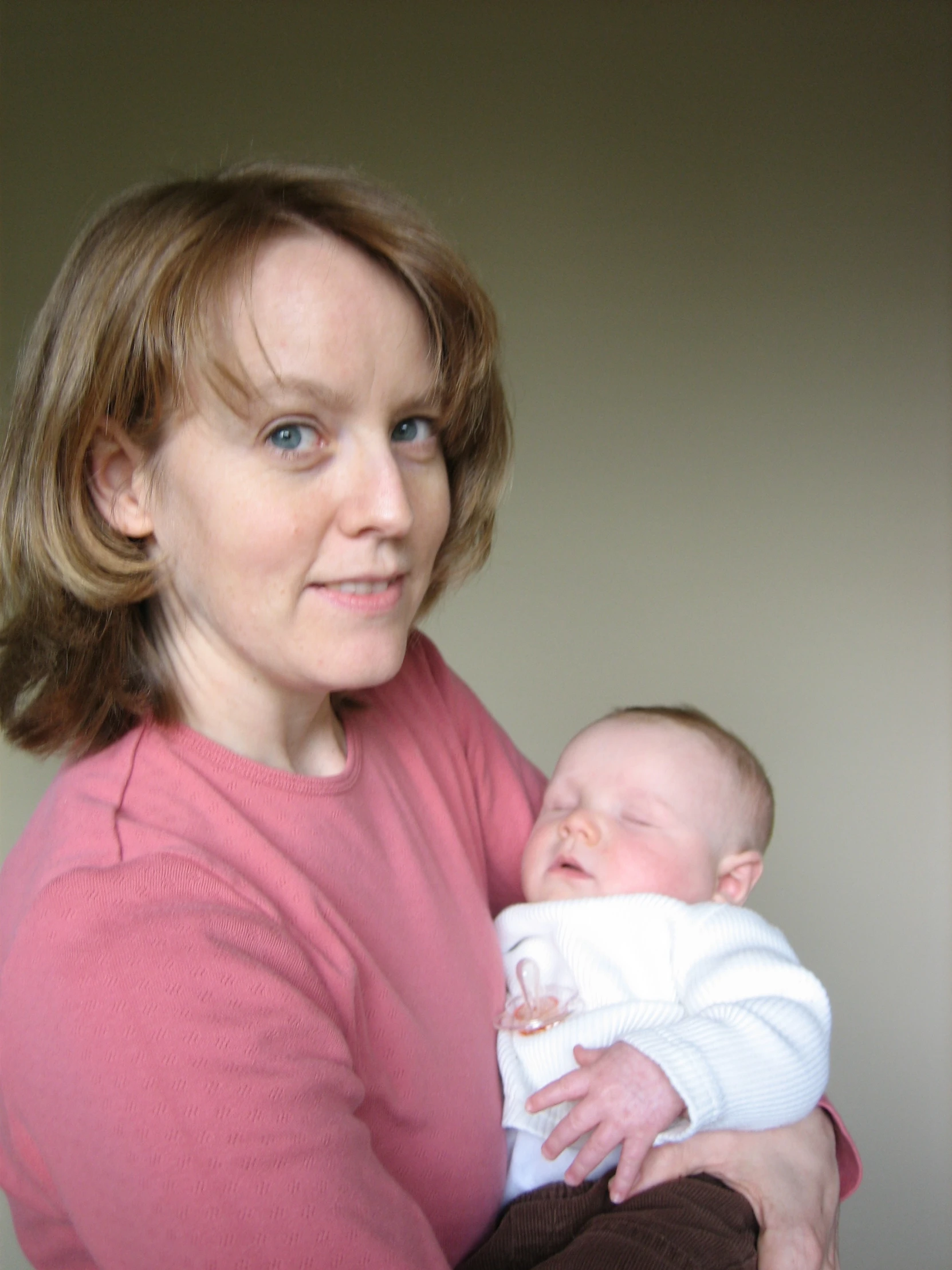 a woman holding a baby in her arms