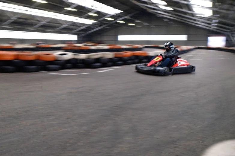 a person riding on a go - cart down a track