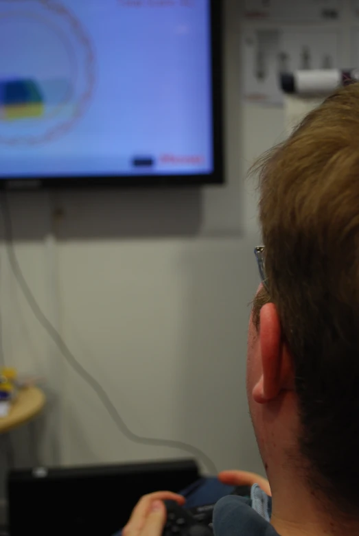 a man playing video games in front of the tv