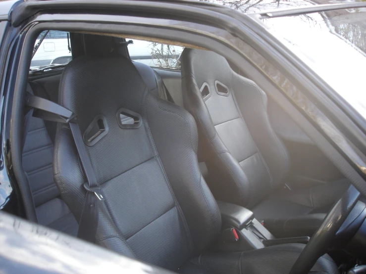 the inside of a car with gray seat covers