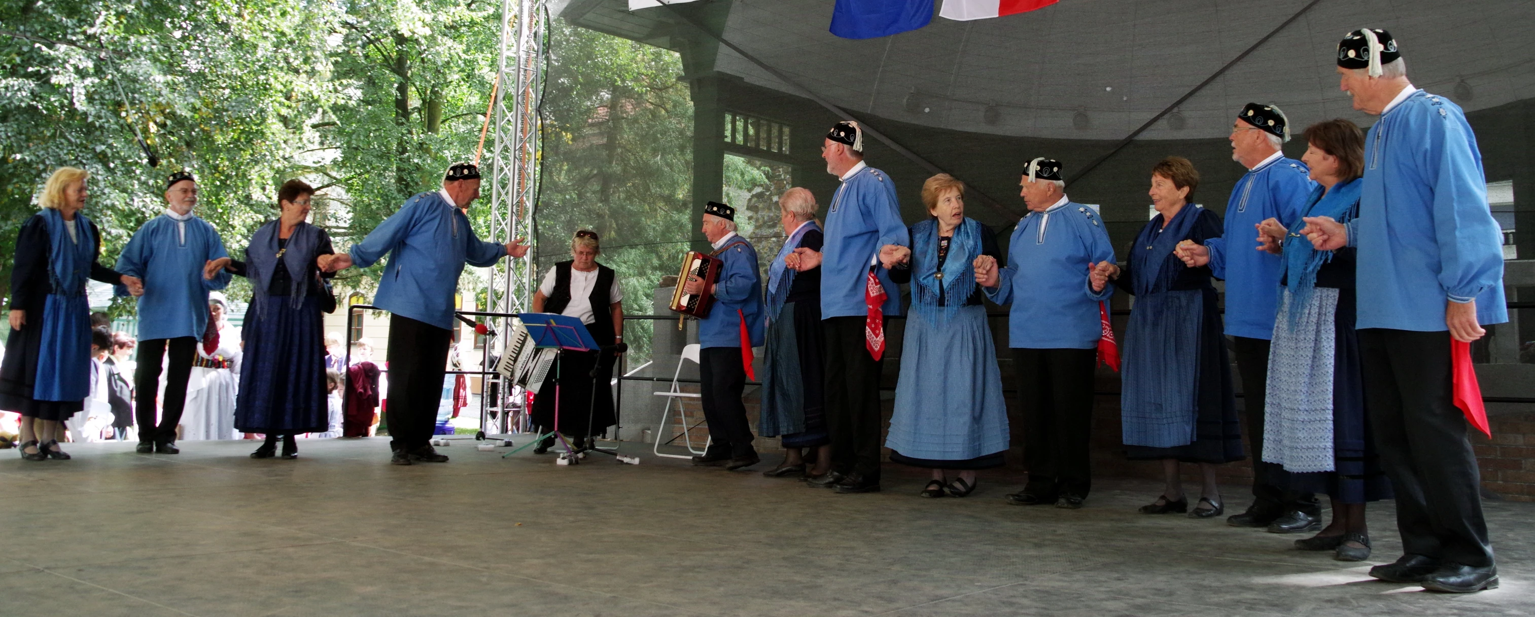 a crowd of people wearing blue standing around each other