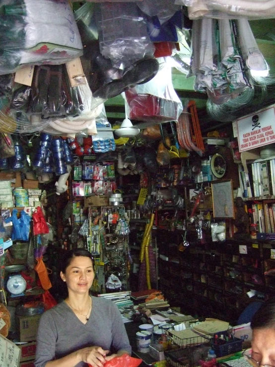 a woman is selling stuff at a store