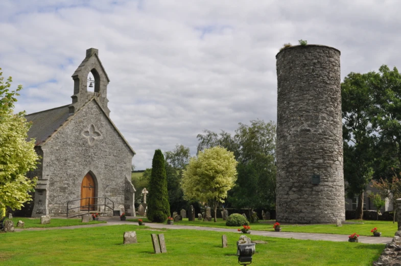 two towers and grass with trees in the background