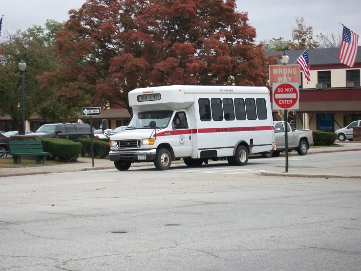 a white truck sitting in front of an american flag