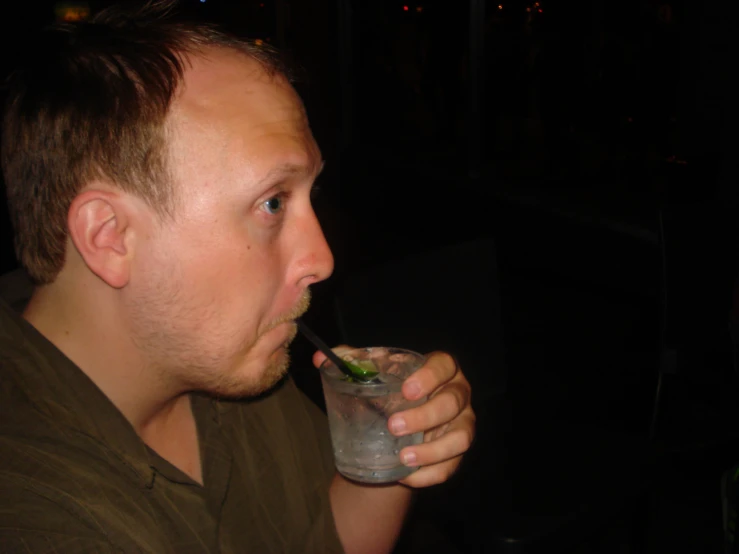 a man is taking a drink while drinking soing