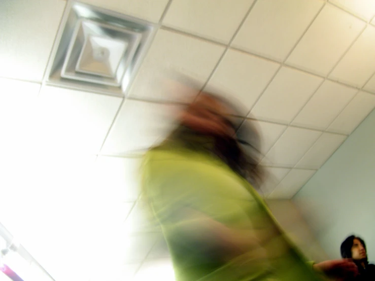 blurry image of a woman walking into the bathroom