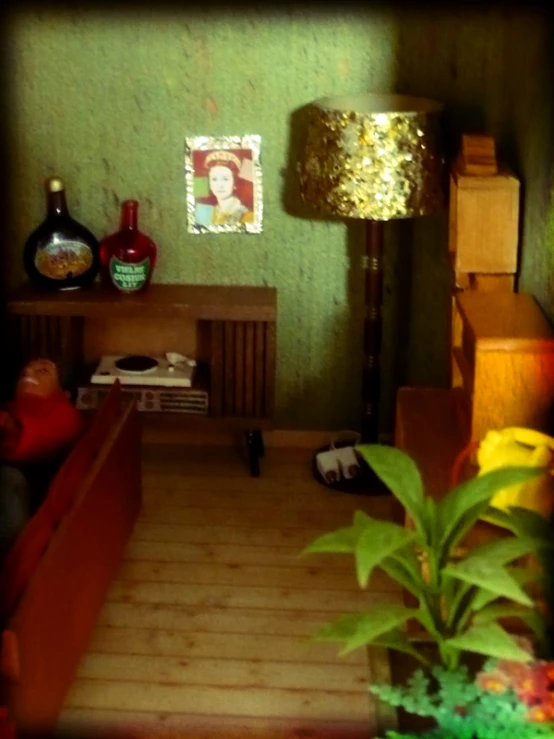 a green room with pictures and a plant in the corner