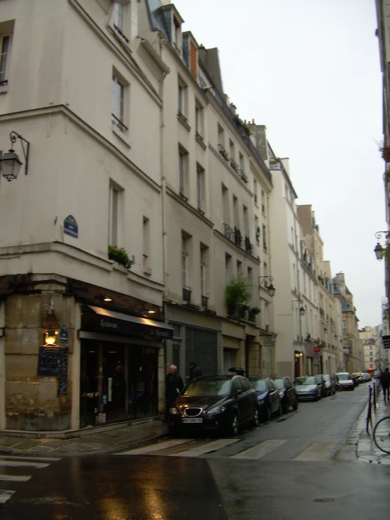 cars are parked along the street in a city