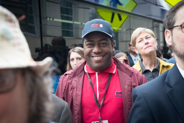 a smiling man in a hat and jacket