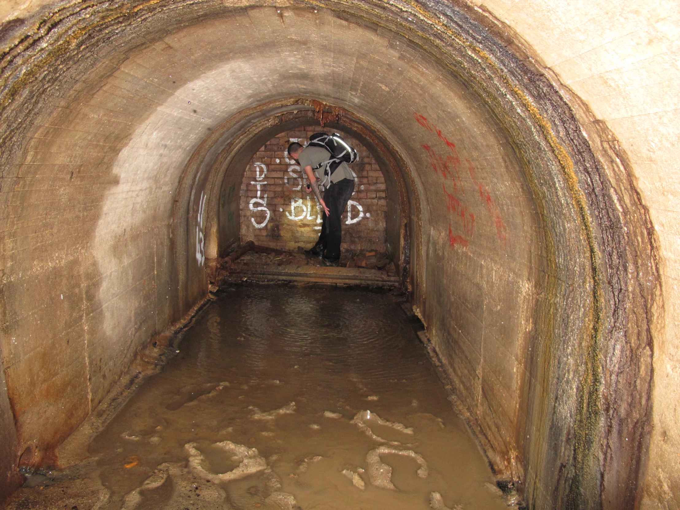 there is an old tunnel that has graffiti on the walls