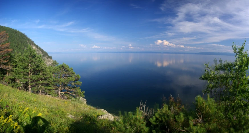 the view of a lake through some trees