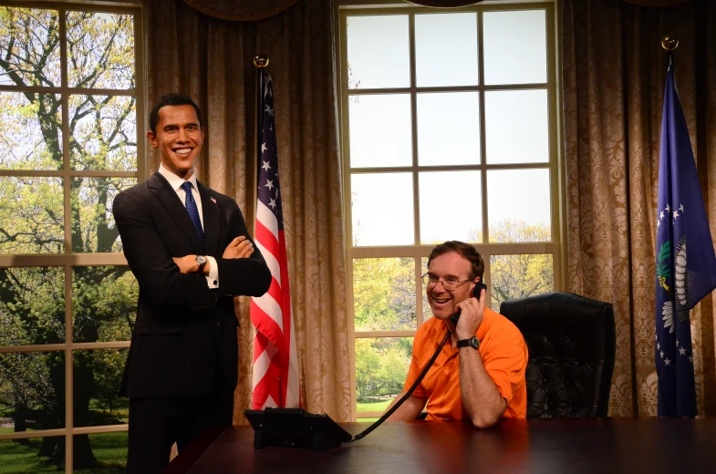 a man talks on a telephone next to an official