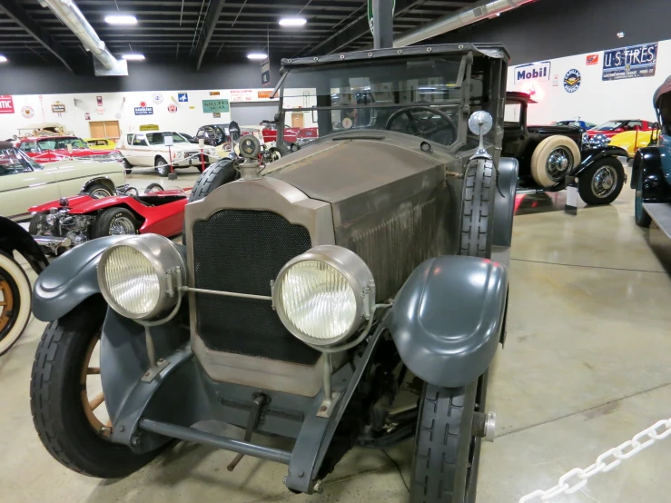 an old - fashioned classic automobile is in a showroom