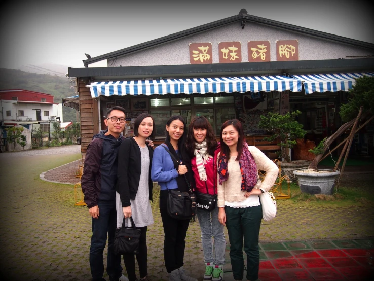 group of asian women standing outside a business