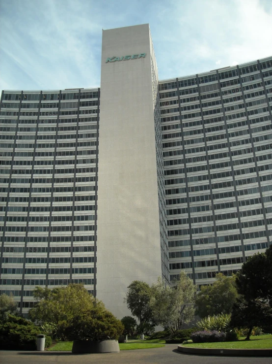 a very tall building with trees in the foreground