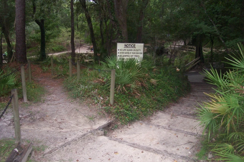 a sign sitting on the side of a wooden staircase