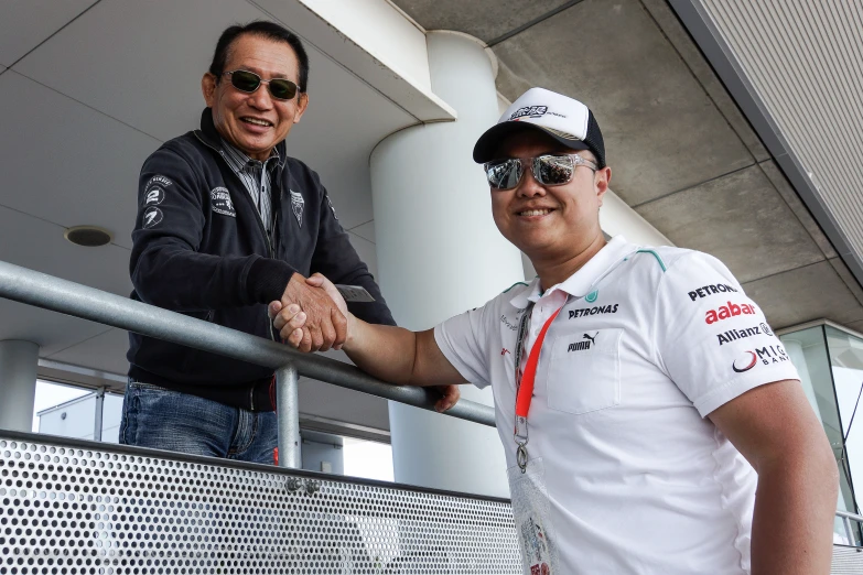 two men shake hands outside an airport terminal