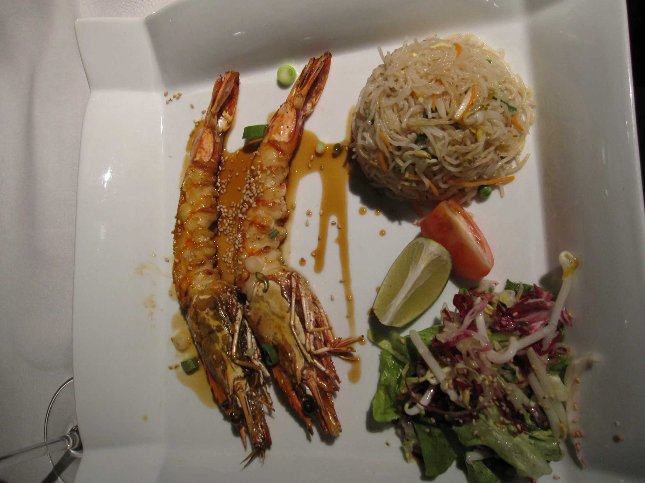 cooked shrimp, rice and green vegetables served on plate