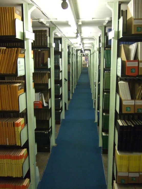 several rows of shelves and file binders in a large room