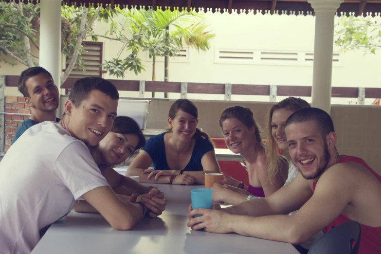 group of friends sitting and smiling at table