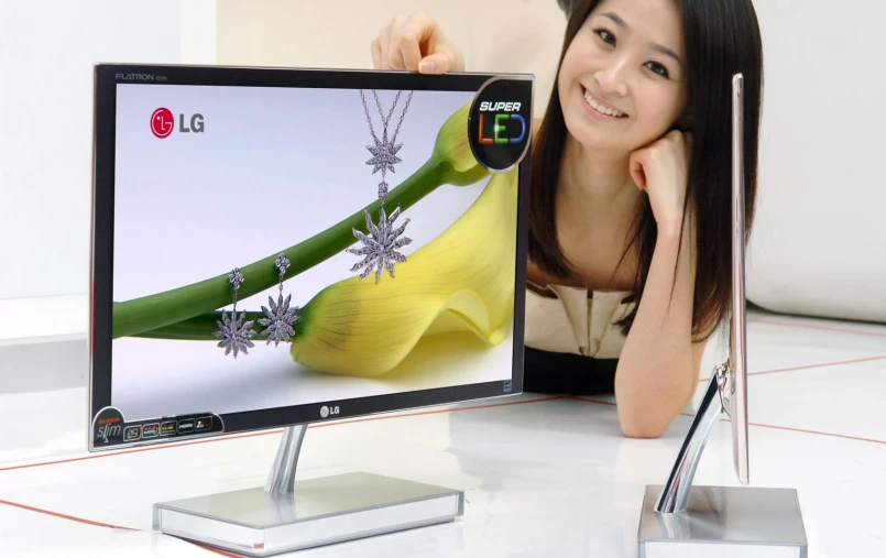 a woman leaning on a desktop with a necklace