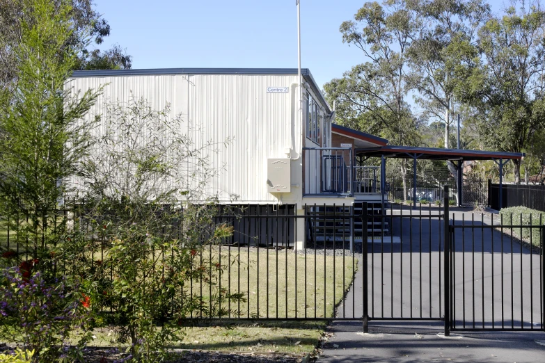 a metal fence near a white building