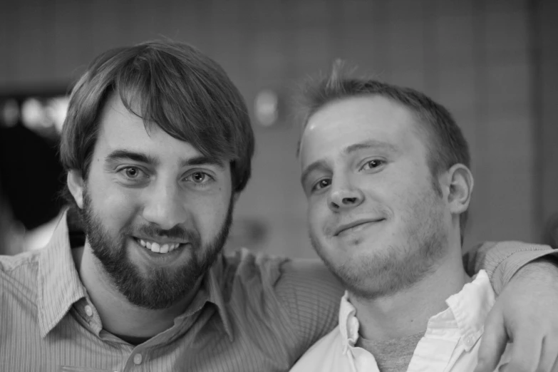 two men in shirts are posing for a po