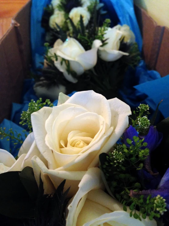 a box with some white roses in it