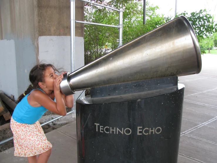 the child is playing with a big metal object