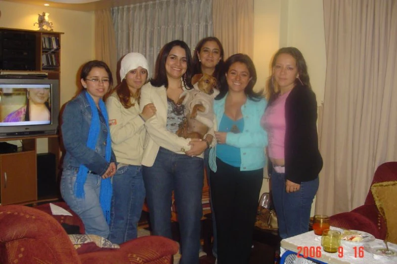 group of ladies posing for the camera in a living room