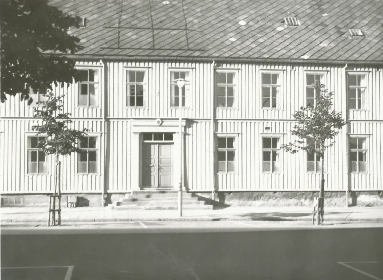 an old black and white po shows a tall building that has been renovated