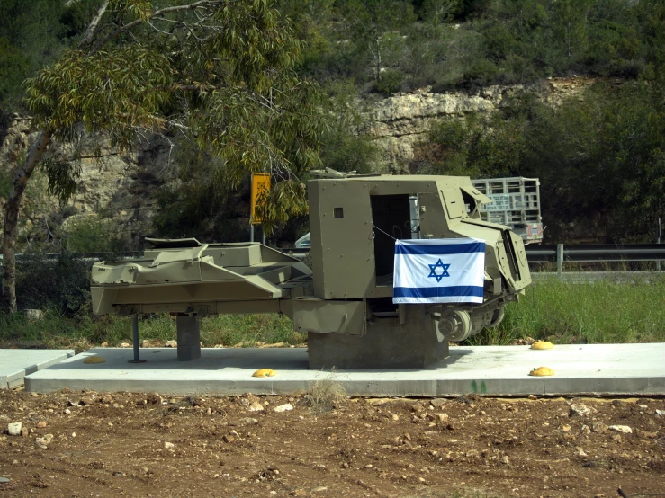 an israeli tank sitting on top of a cement bench