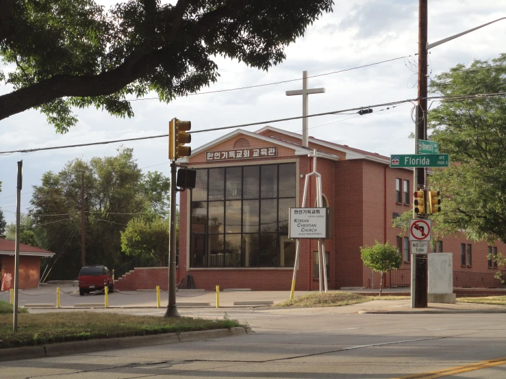 a large building with cars parked next to it on the side of a street