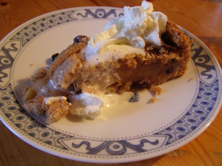 piece of pie with whipped cream on top on a plate