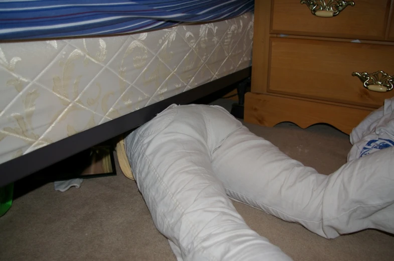 a mattress lays on the ground between two wooden drawers