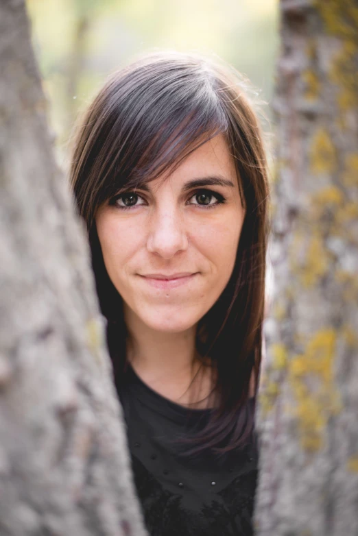 a pretty young woman with a black shirt behind her